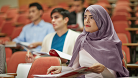 Young woman sitting in lecture theatre